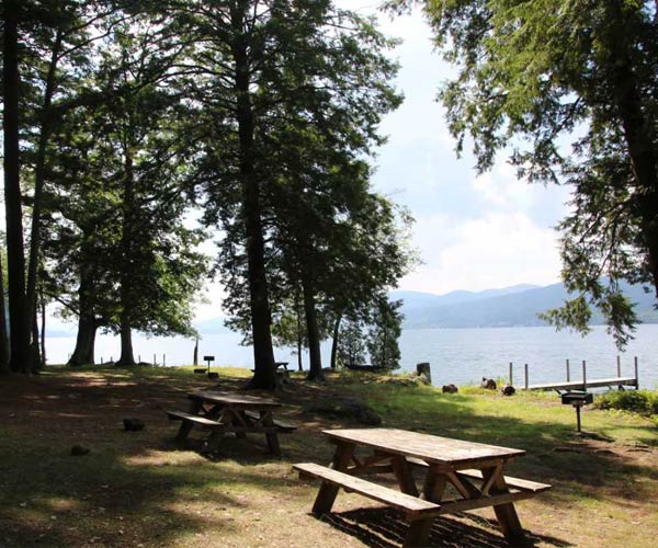 picnic tables and grills on speaker heck island overlooking lake george