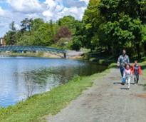 family walks in washington park near bridge