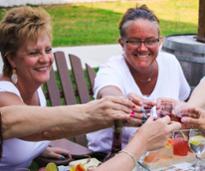 women cheers at adirondack winery patio
