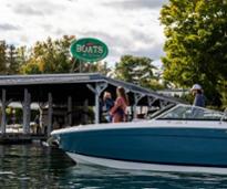 family on boat by boats by george sign
