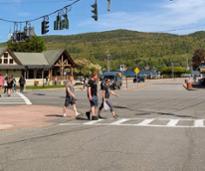 three guys crossing the street in lake george