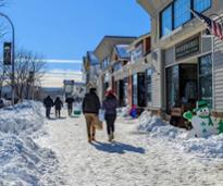 people walking down street in lake george village in winter