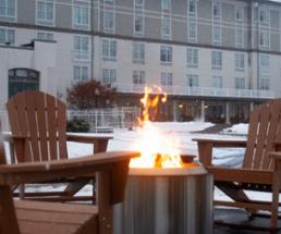 fire in fire pit outside in winter in front of fort william henry hotel in lake george