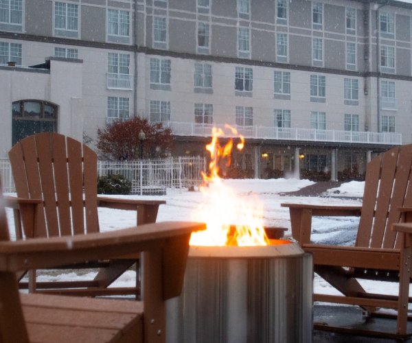 fire in fire pit outside in winter in front of fort william henry hotel in lake george