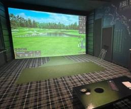 an indoor golf simulator area