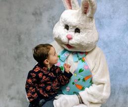 toddler sits on easter bunny's lap