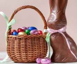 chocolate easter bunny with a basket of chocolate eggs