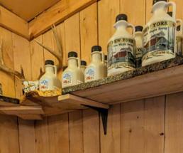 jugs of nys maple syrup on shelf