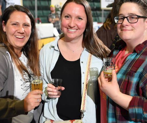 three people pose at glens falls brewfest