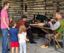 family talks to reenactor soldiers at fort william henry