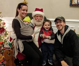 family poses with Santa