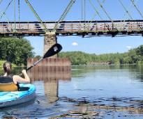 kayaking under a bridge