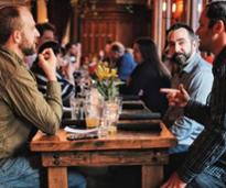 group of men seated at a beer hall table