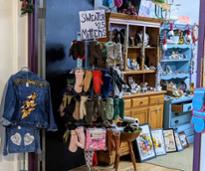 sweater and mittens for sale at storefront
