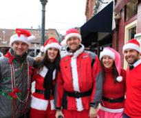 group of people dressed for a santacon