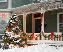 house decorated for Christmas outdoors with tree and lights