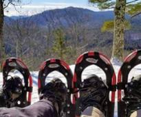 two pairs of snowshoes together on winter mountainside