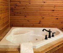 hot tub with wood paneling surrounding