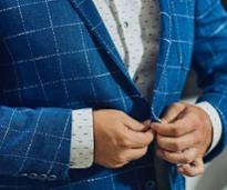 closeup of man buttoning blue jacket