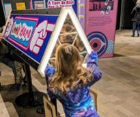 little girl looks into exhibit at misci