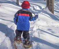 the back of a little kid snowshoeing