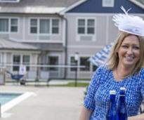 woman in track hat in front of hotel