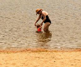 woman with toddler in lake
