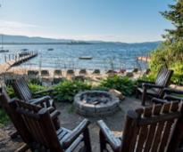 chairs around fire pit in front of lake george