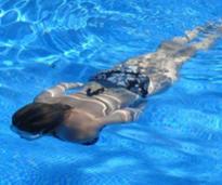 woman swims in pool underwater