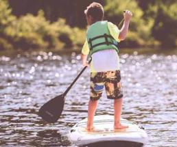 kid standup paddleboarding