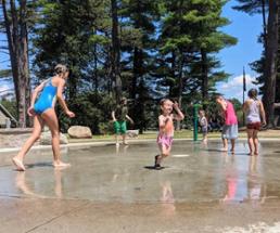 kids at a splash pad in crandall park