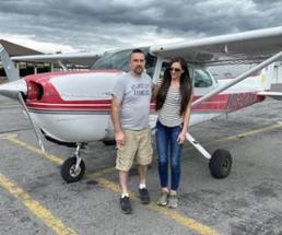 couple poses in front plane