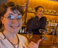two women at a bar, one is the bartender