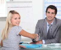 man and woman shaking hands at job interview