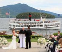 wedding ceremony by lake with steamboat in background