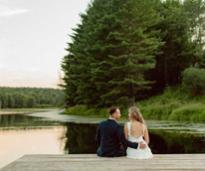couple seated on a dock smiling