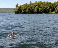 person swimming in lake george