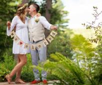 couple holds up sign saying they eloped