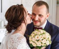 bride kisses groom on the cheek