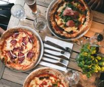 pizza and basil on table