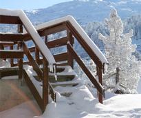 stairs covered in snow leading up to a porch