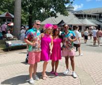 people dressed up in pink for Whitney Day at Saratoga Race Course