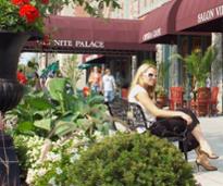 woman sits on bench on broadway in saratoga