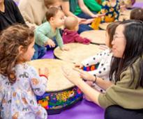 kids and adults at hand drums