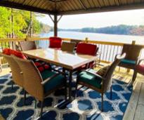 back deck with dining table at lakefront vacation rental