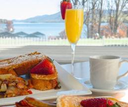 brunch plate on table with foliage views out window in front of it