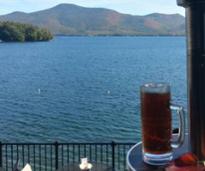 foliage view over lake george with beer in foreground