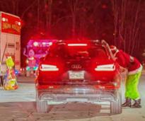 drive-through holiday event with the grinch poking his head in a car