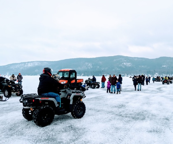people and ATVs on a frozen lake