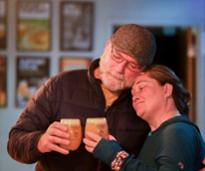 man and woman embracing with beer